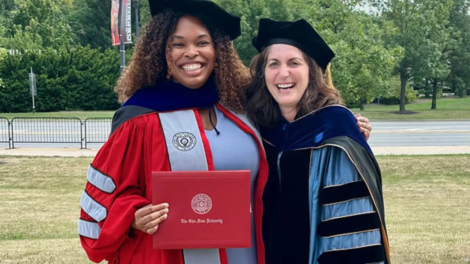 Chris Bijou and Cindy Colen wearing doctoral graduation regalia