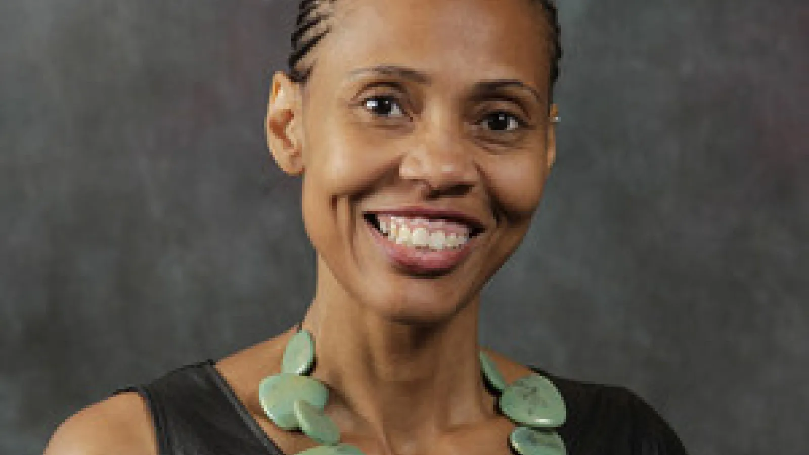 Female graduate student smiles at camera